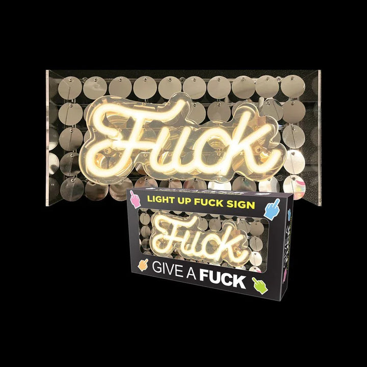 Fuck LED neon sign lit on a gold disc backing, shown beside its retail box