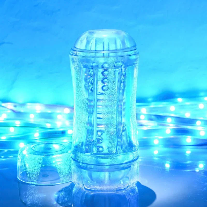 Gender X Double Fantasy stroker in Clear standing upright, blue LED backdrop