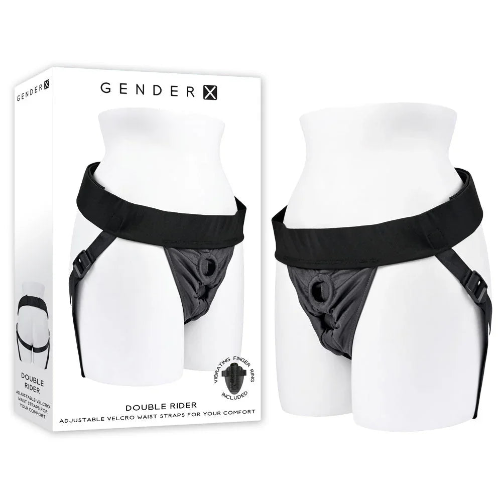 Gender X Double Rider harness in Black worn on a mannequin torso, beside its retail box