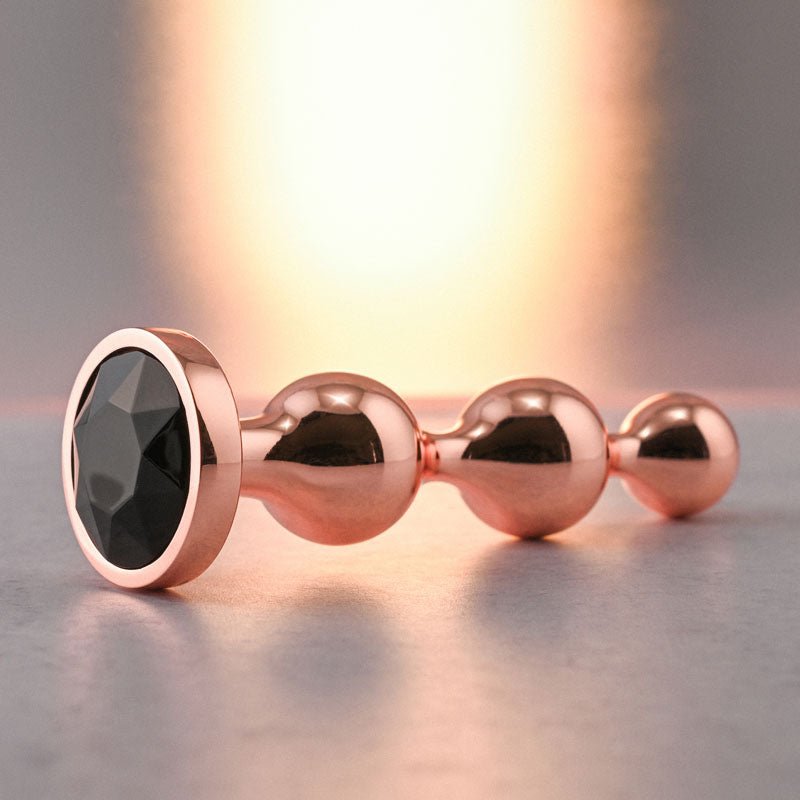Buy Gender X GOLD DIGGER SMALL - Rose Gold Small Butt Plug with Black Gem Base – Naughtyhut NZ sex toys online. Discreet delivery & top brands.