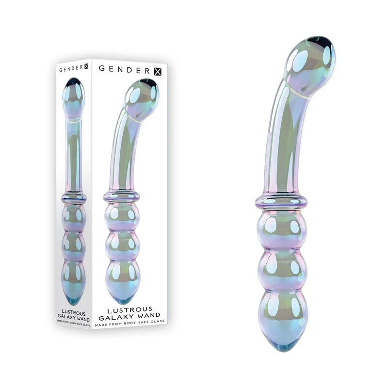 Gender X Lustrous Galaxy Wand in Blue/Violet glass beside its retail box on white