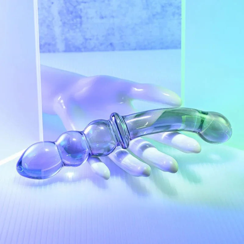 Gender X Lustrous Galaxy Wand resting across a white mannequin hand for scale
