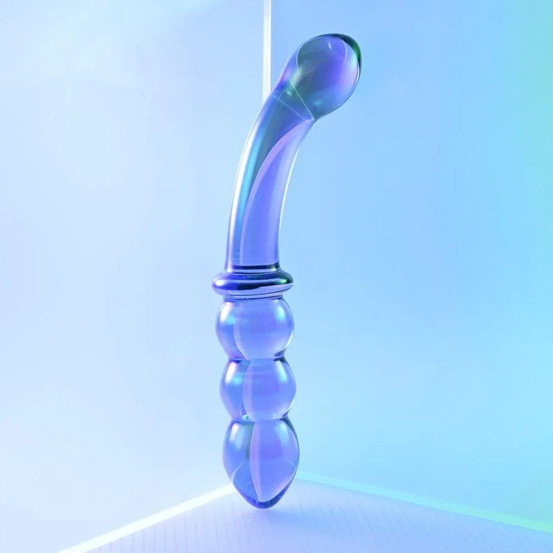 Gender X Lustrous Galaxy Wand stood upright on its beaded end under blue light