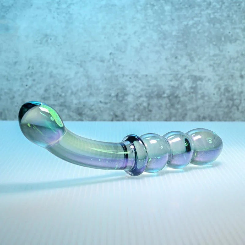 Gender X Lustrous Galaxy Wand lying flat, curved bulb end and three-bead end in view