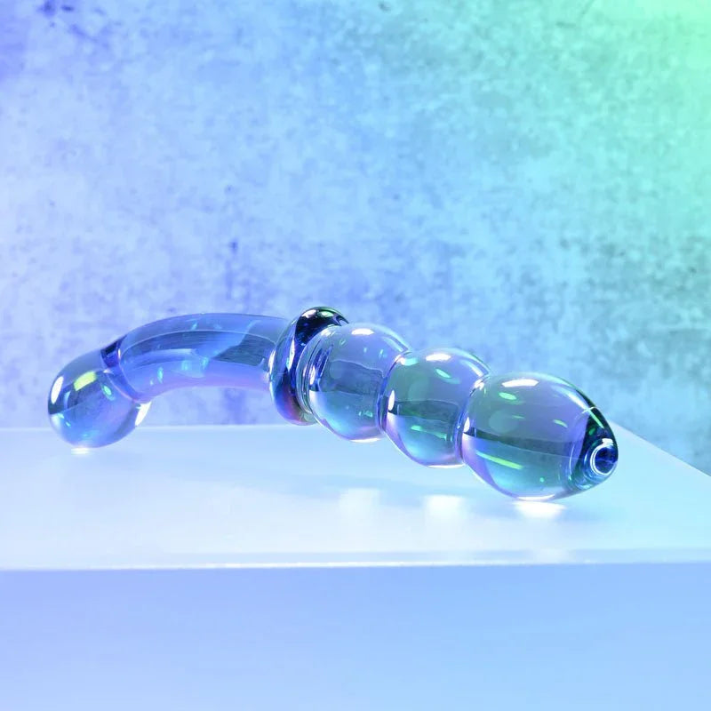 Gender X Lustrous Galaxy Wand laid on a white block, low angle showing the iridescence