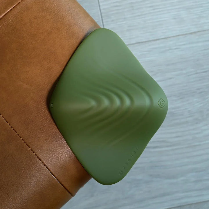 Gender X Pleasure Pad in Green propped on a sofa arm, side profile of the ridges