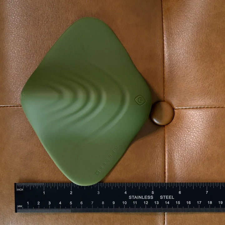 Gender X Pleasure Pad in Green beside a steel ruler for scale