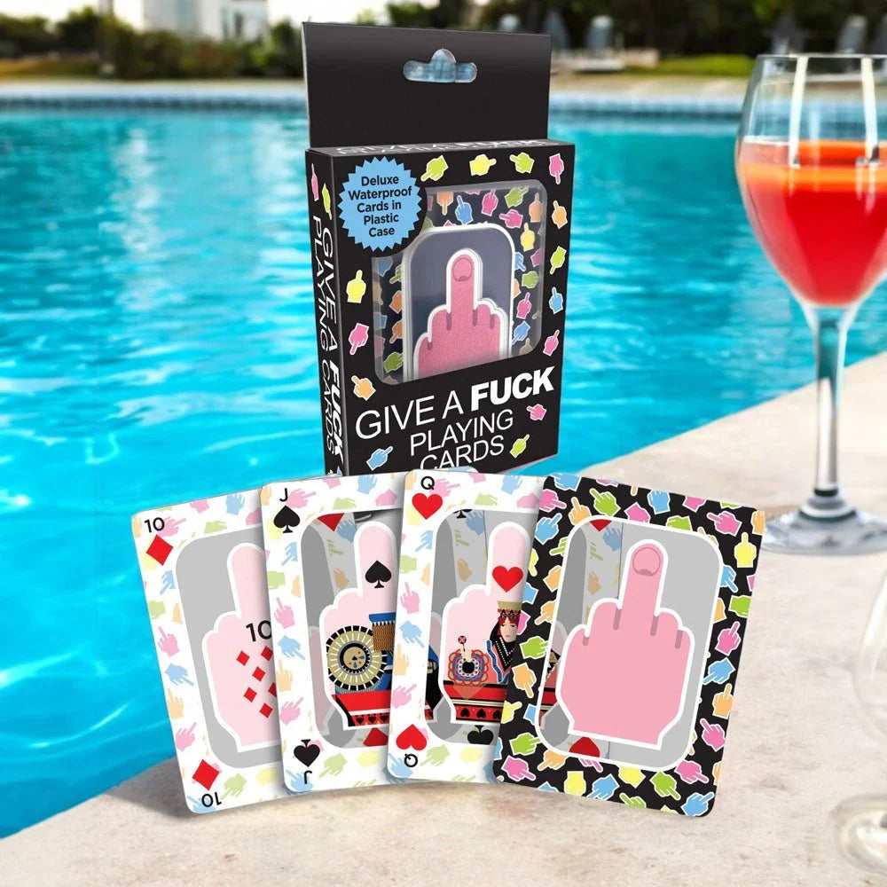 Give A Fuck Playing Cards staged poolside beside a cocktail glass