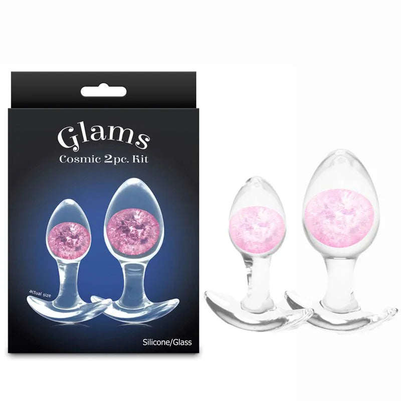 Glams Cosmic 2pc kit, two clear glass plugs with pink glitter gems beside the Glams box