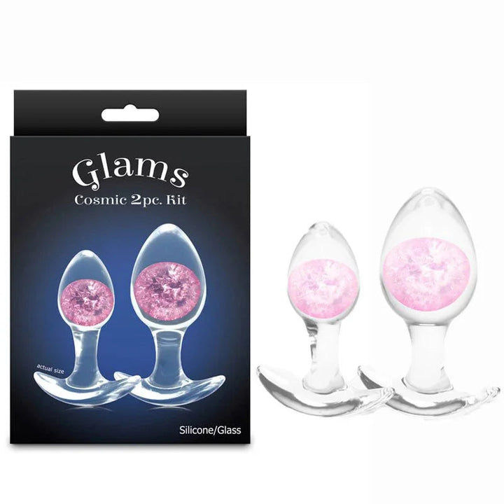 Glams Cosmic 2pc kit, two clear glass plugs with pink glitter gems beside the Glams box