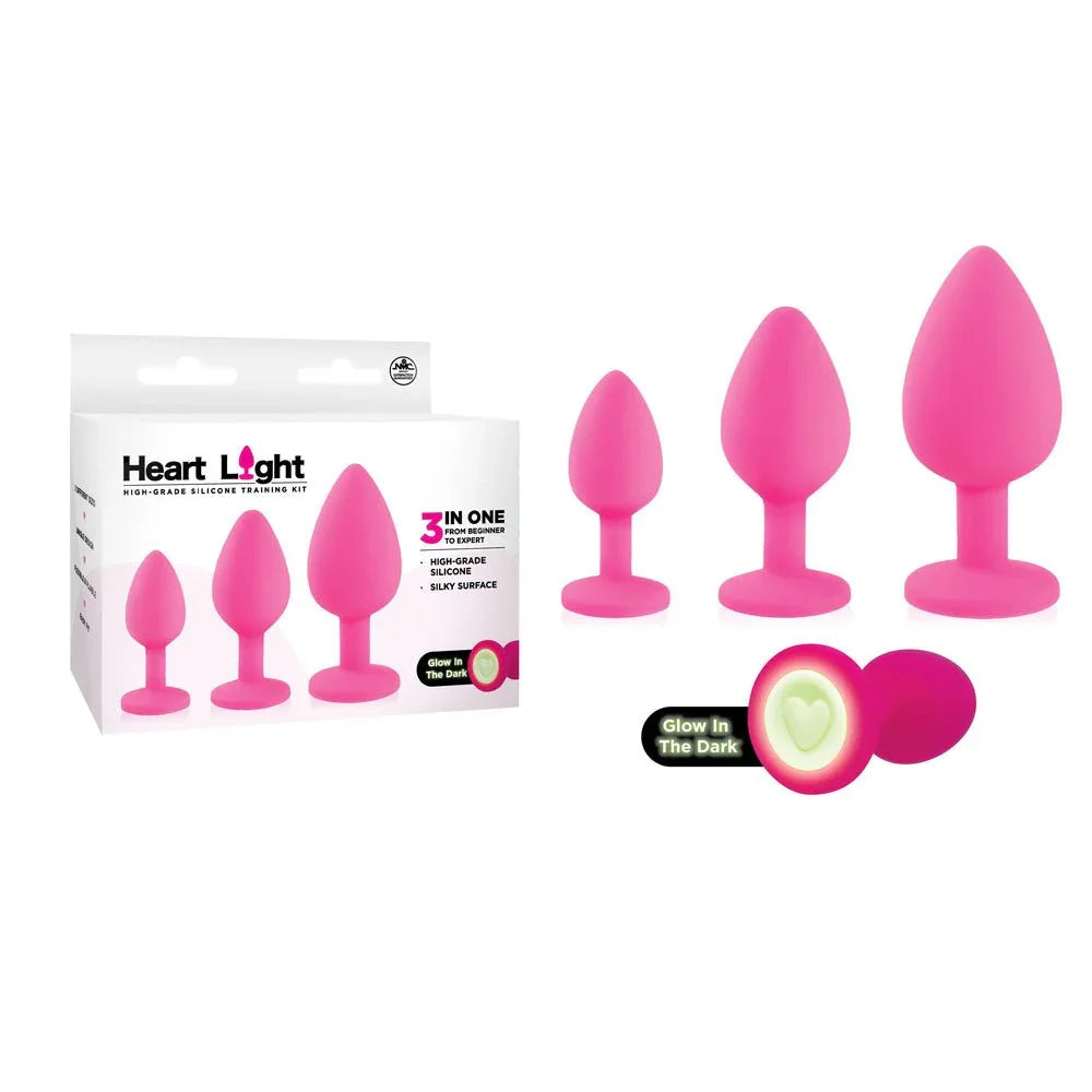 Heart Light butt plug set in Pink, three sizes with glow-in-the-dark heart bases, and box