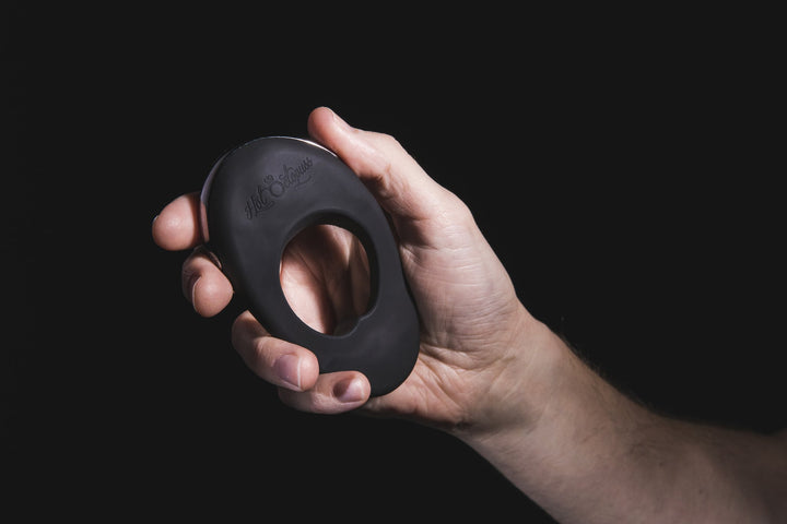 Atom Plus in the palm of a hand, showing its oval shape and logo