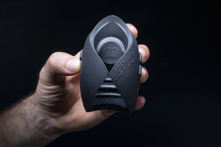 Hand holding the black Hot Octopuss Pulse Solo Essential, crown logo facing out