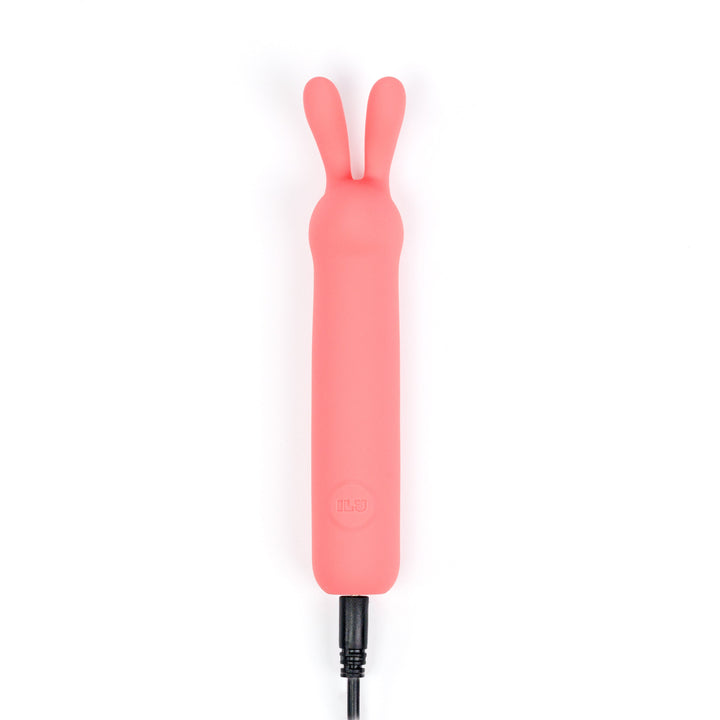 ILY The Rabbit coral pink vibrator with USB charging cable attached at the base
