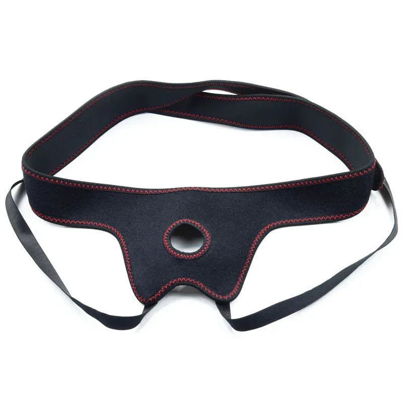 Black Ingen strap-on harness laid flat, showing the O-ring opening and adjustable straps