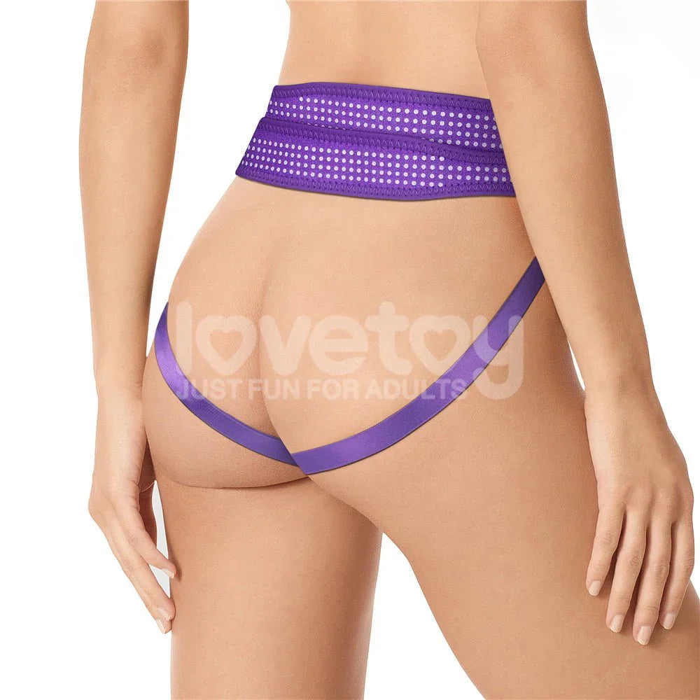 Rear view of a model in the purple Ingen harness, waistband and strap across the buttocks