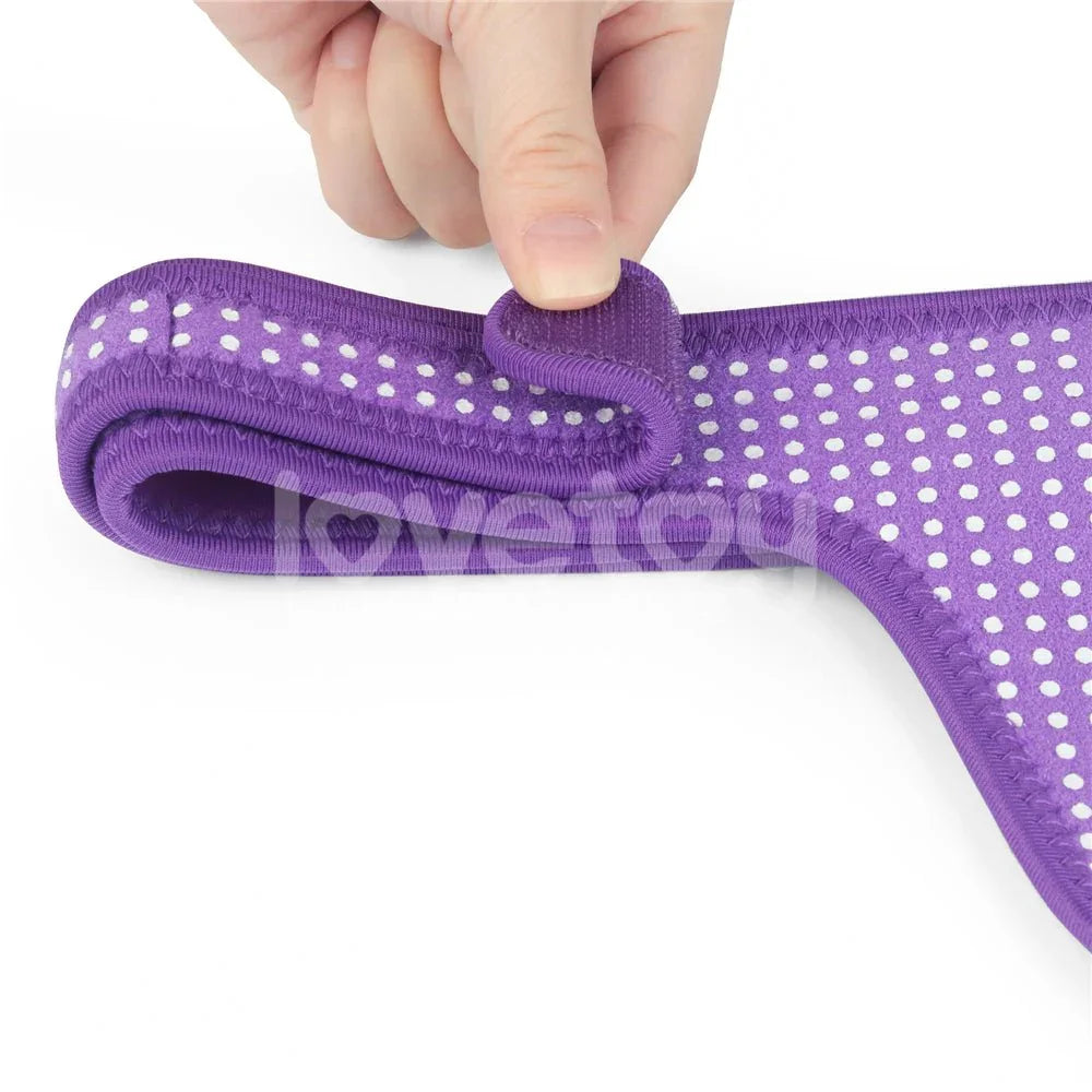 Fingers peeling open the velcro fastening on the purple Ingen harness waistband