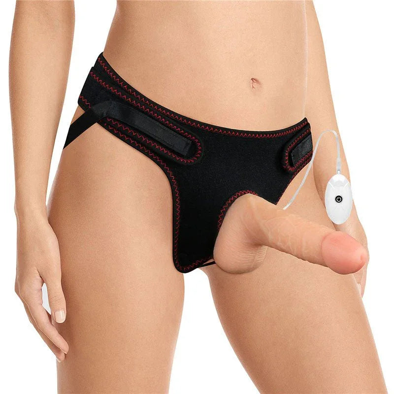 Model in the black Ingen vibrating harness with the flesh dildo fitted and remote hanging at the hip