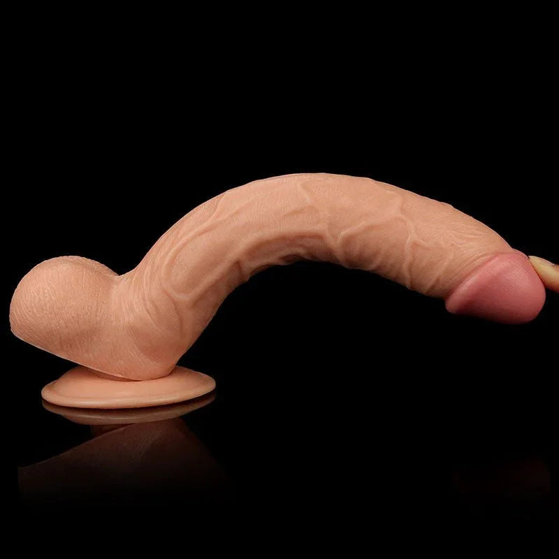 King Size 10 inch dildo curved forward on its suction base against black