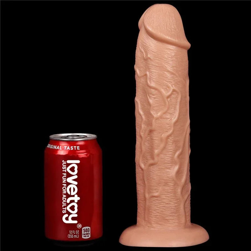 King Size 11 inch dildo upright beside a soft drink can, showing its scale