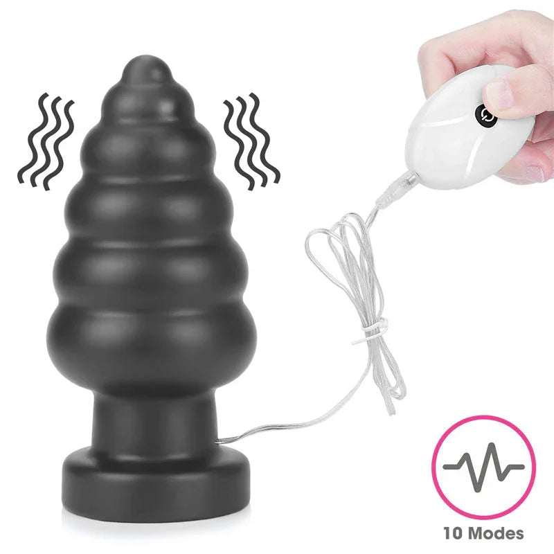 Black ribbed Anal Cracker plug with vibration lines and a hand holding the white remote, 10 modes