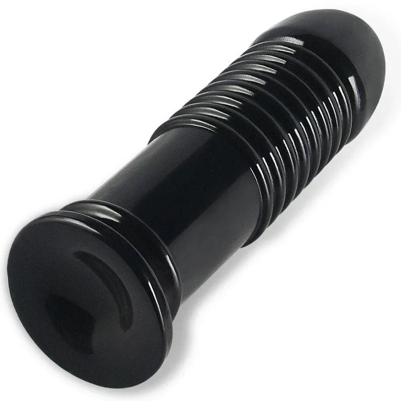 Black Anal Bumper plug lying down, viewed along the ribbed shaft toward the base