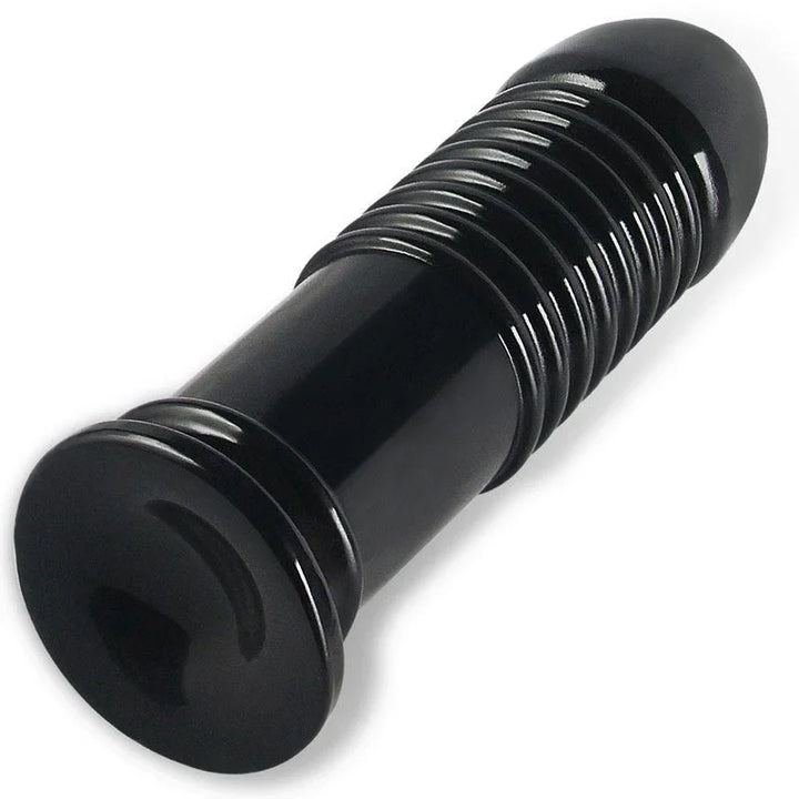 Black Anal Bumper plug lying down, viewed along the ribbed shaft toward the base