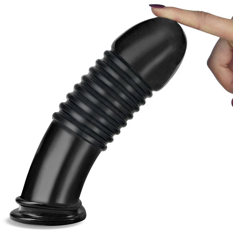 Fingertip tipping the black Anal Bumper plug over on its flared base