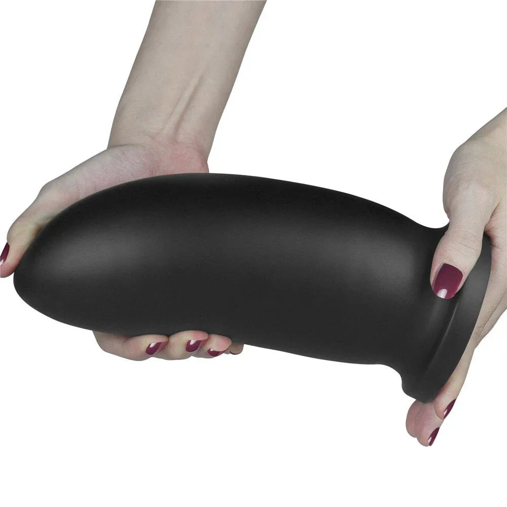 Two hands holding the black Anal Bomber horizontally to show its full bullet shape