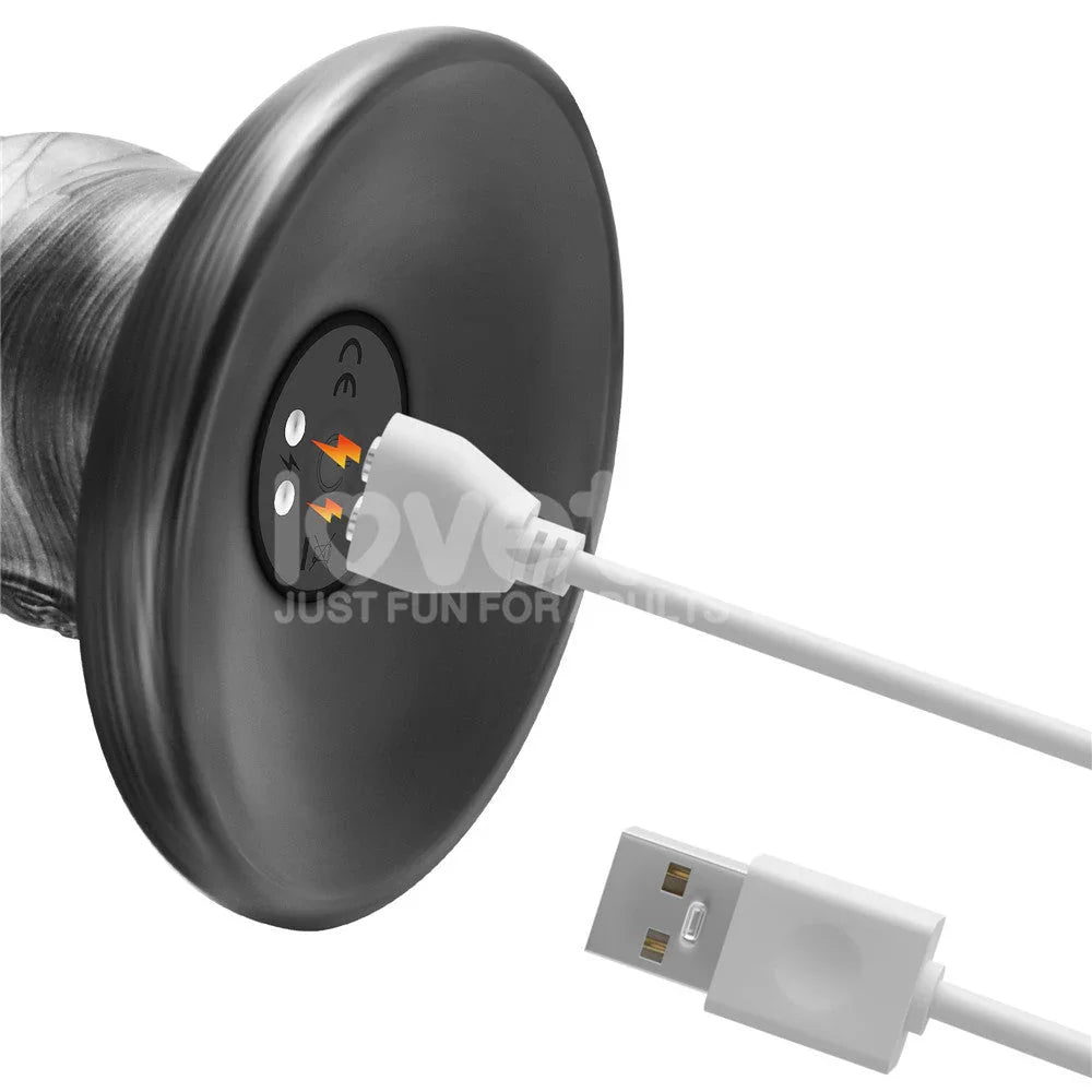 White magnetic USB cable connected to the base of the grey Vibrax Slider 16 inch