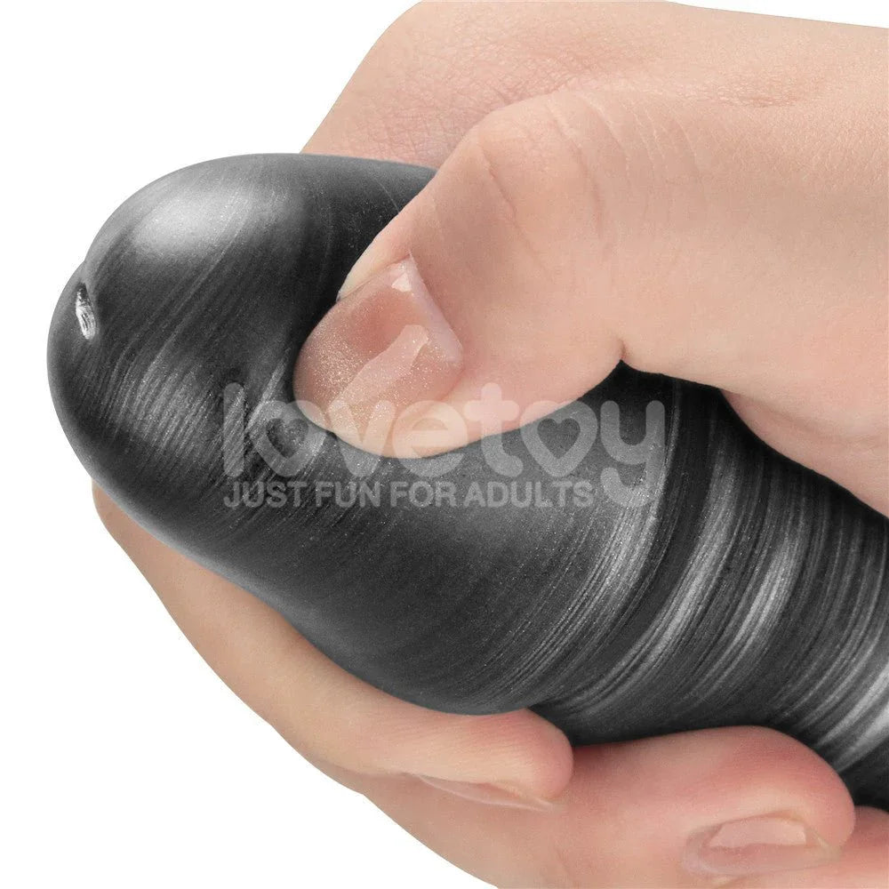 Hand squeezing the marbled grey shaft of the 16 inch Vibrax Slider