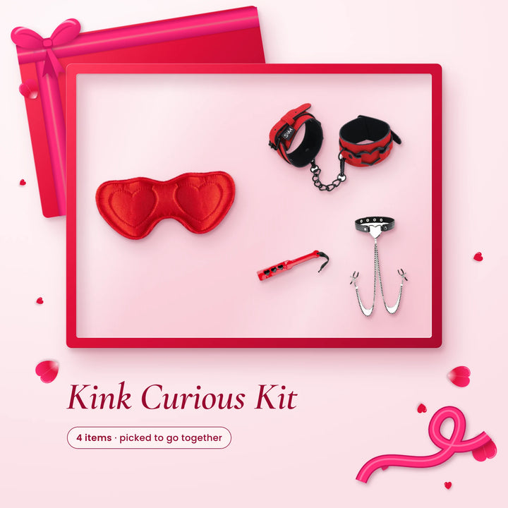 Kink Curious Kit: a red heart satin blindfold, red cuffs, a heart spanking paddle and a collar with nipple clamps