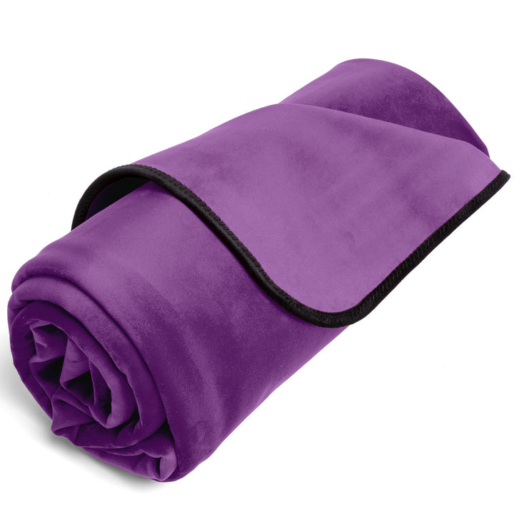 Purple Fascinator throw partly rolled up, showing its black trim edge