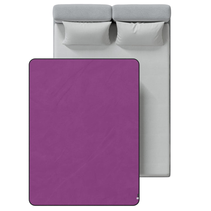 Top-down view of the purple Fascinator throw on a queen bed, showing its size