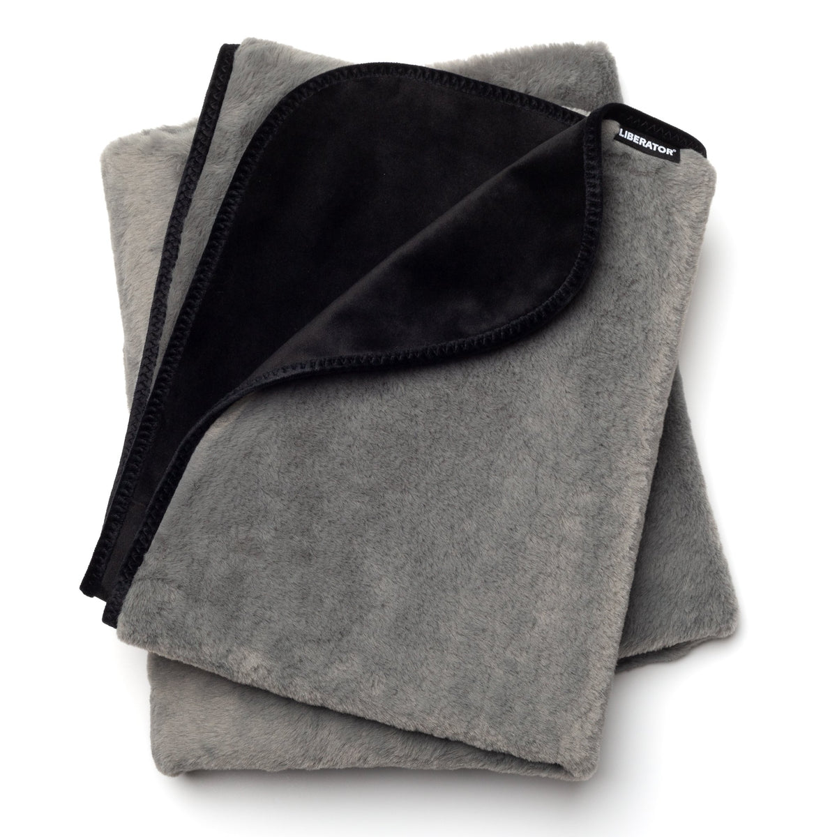 Liberator Fascinator faux-fur throw folded, grey fur side and black microvelvet side