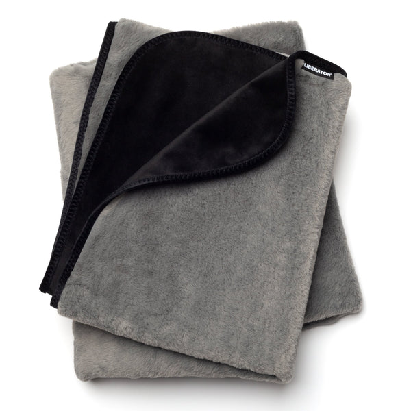 Liberator Fascinator faux-fur throw folded, grey fur side and black microvelvet side