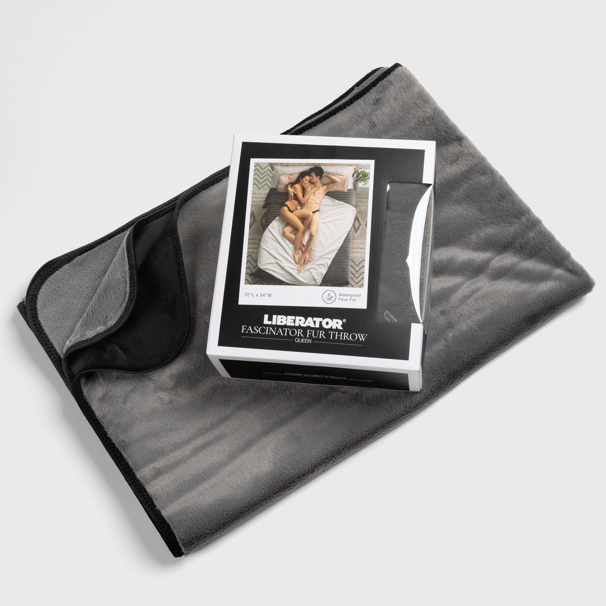 Grey Fascinator fur throw laid flat with its retail box resting on top