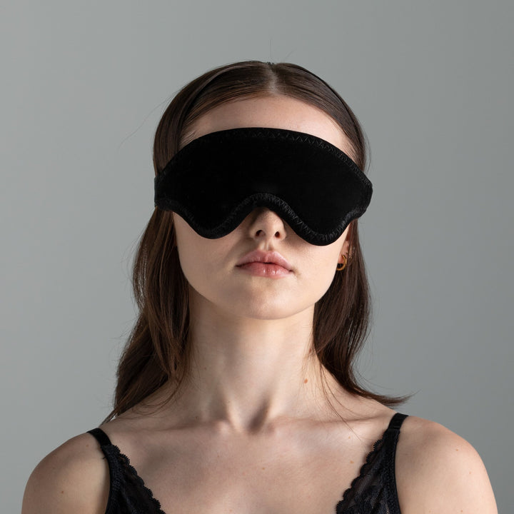 Woman wearing the black LoveBlind blindfold, head and shoulders