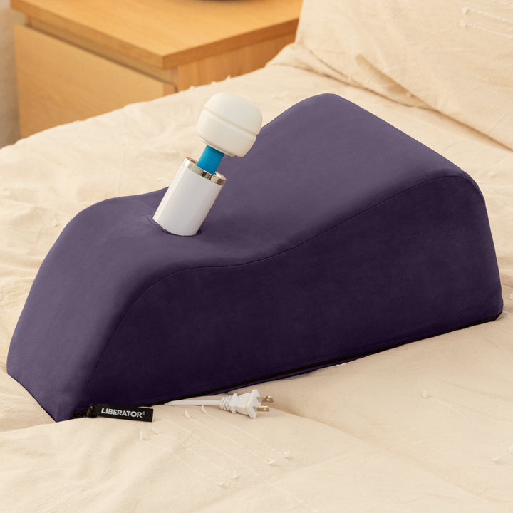 Purple Wanda holding a white wand upright on a cream bed