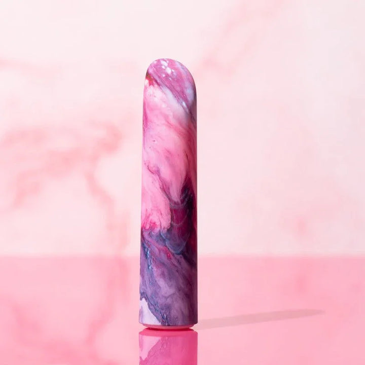 Entangle bullet standing upright against a pink marble backdrop