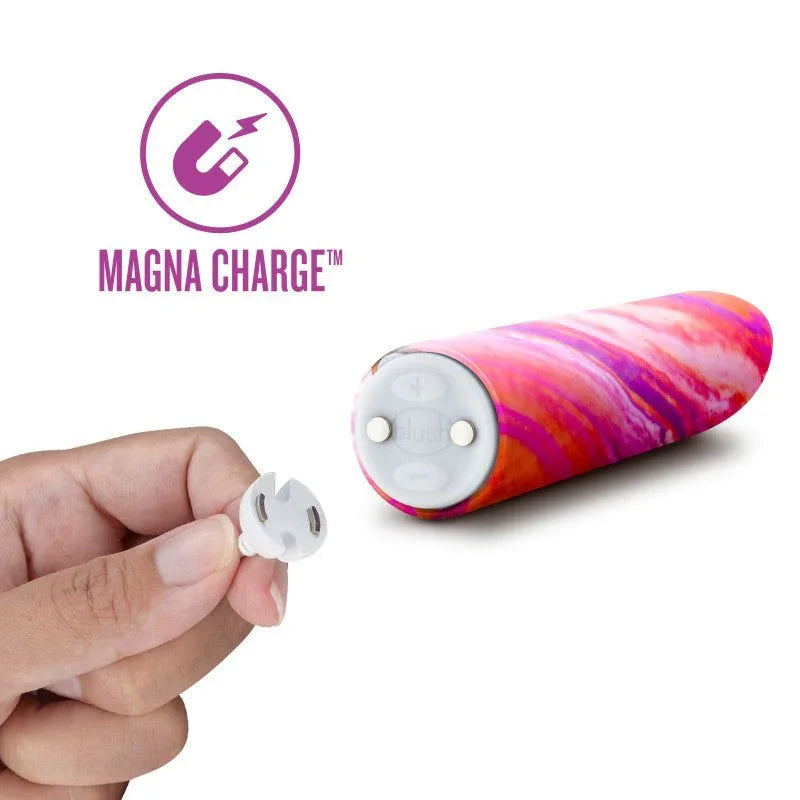 Magna Charge magnetic charger held beside the coral Fiery bullet's contact base