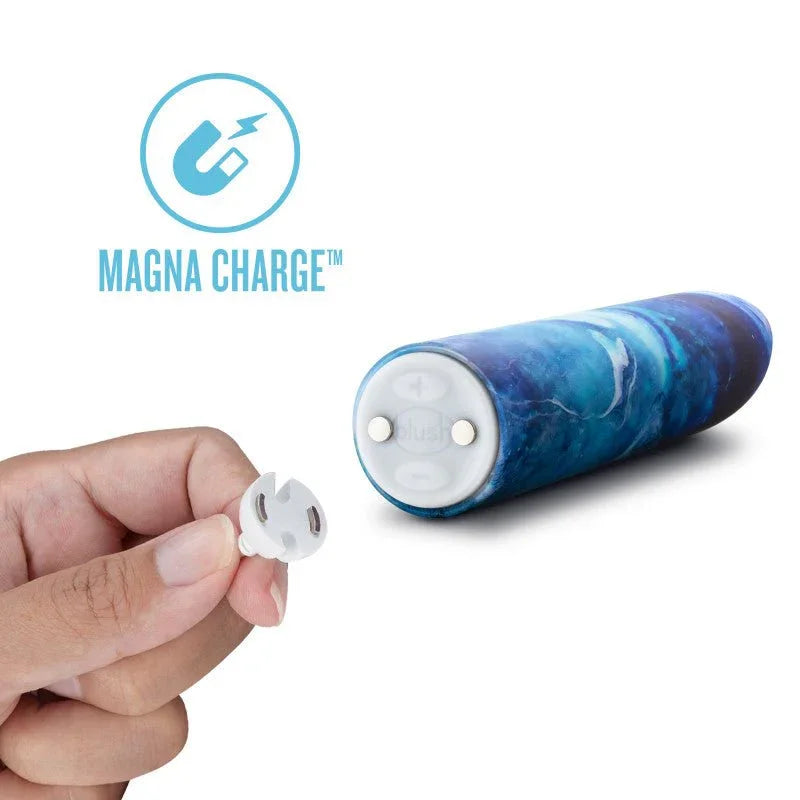 Magna Charge magnetic charger held beside the blue Mesmerize bullet's contact base