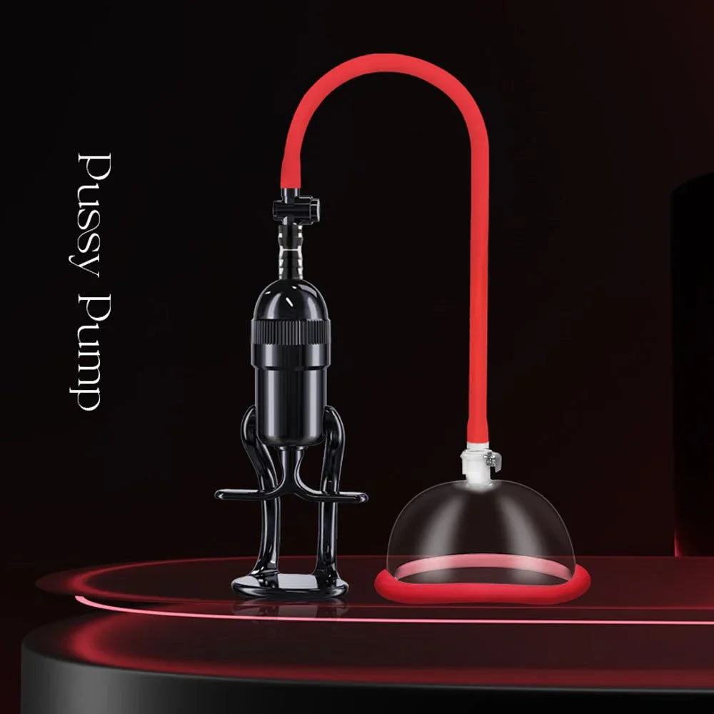 Vagina pump on dark red stage, black hand pump linked to the clear cup