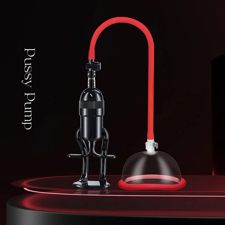 Vagina pump on dark red stage, black hand pump linked to the clear cup