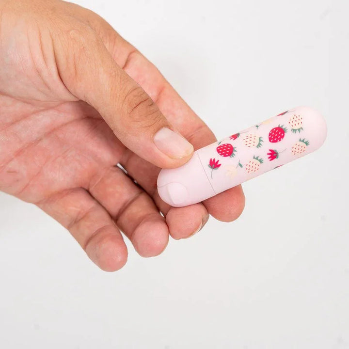 Maia Bari bullet in Baby Pink held between finger and thumb, showing its small size