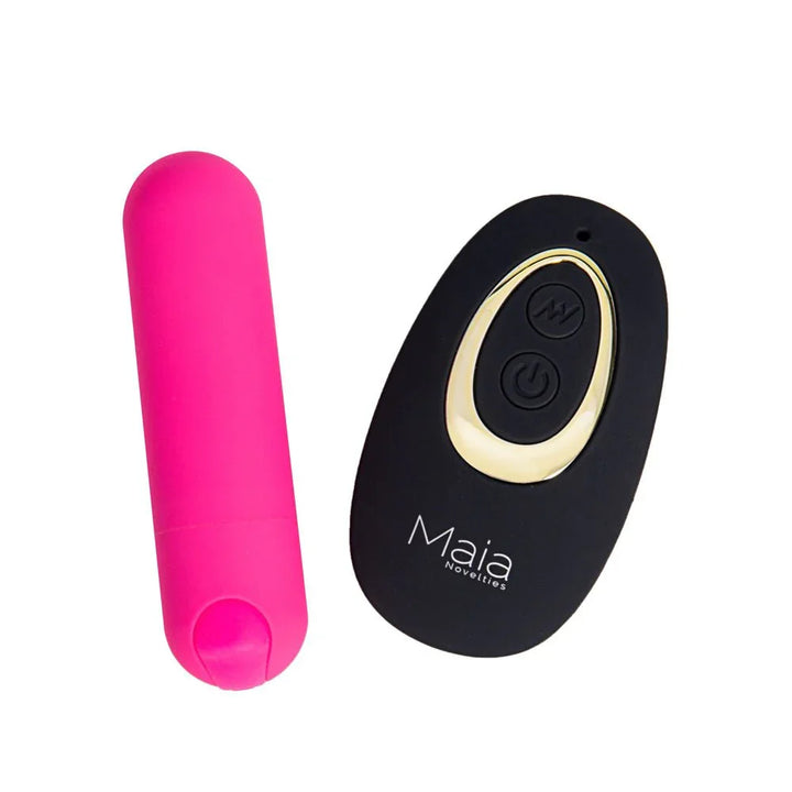 Maia Date Night pink bullet lying beside its black and gold Maia remote