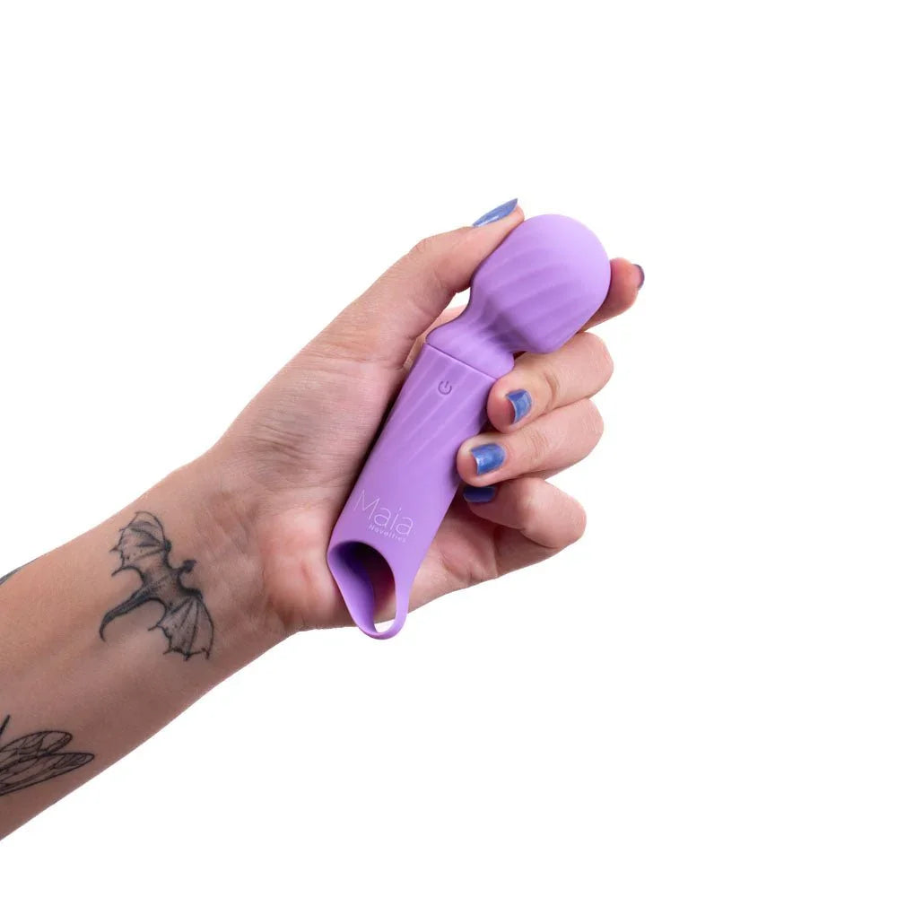 Maia Dolly mini wand in Purple gripped in a tattooed hand, head pointing up