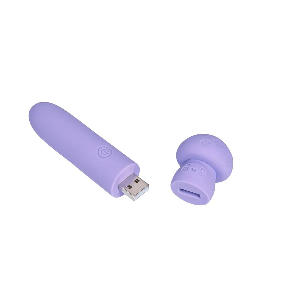Maia Happi mini vibe in Purple laid flat beside its mushroom cap, USB plug exposed