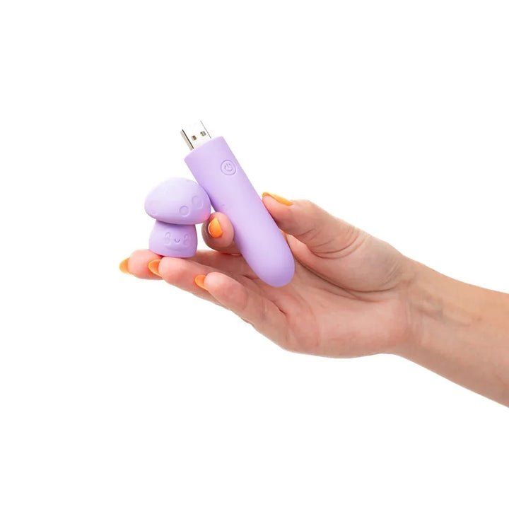 Maia Happi mini vibe in Purple held in a hand, mushroom cap removed to show the USB plug