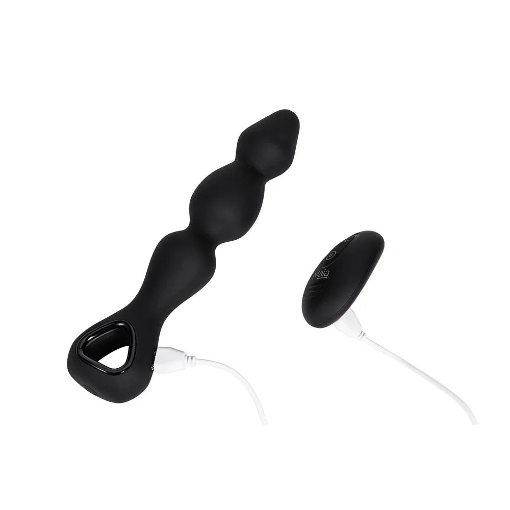 Maia Hudson anal vibrator in Black on charge, cable in the base, remote alongside